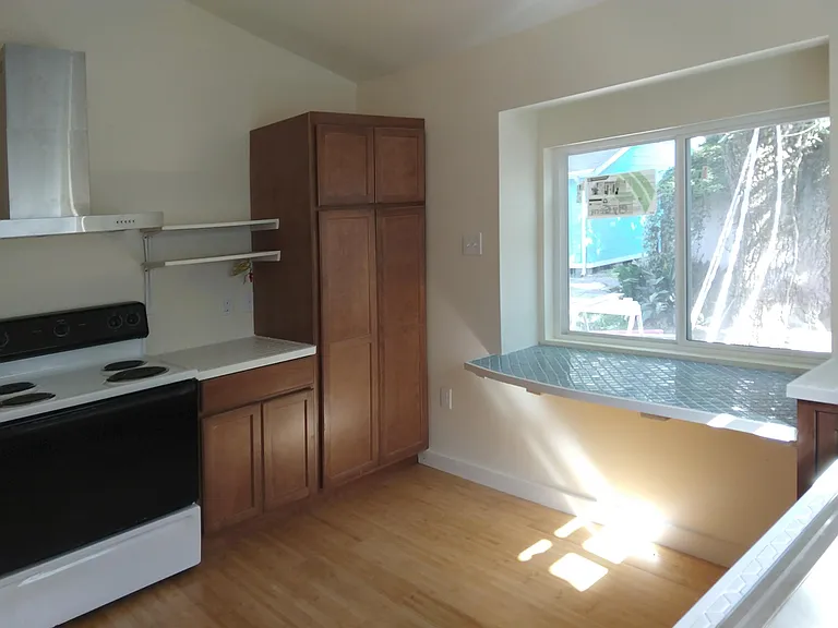 Detail of kitchen: built-in tiled table and big, beautiful window to let in lots of natural light