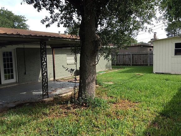 Patio and storage shed. Note big shade tree in the back yard.