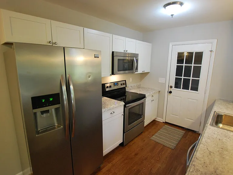 Kitchen includes side-by-side refrigerator