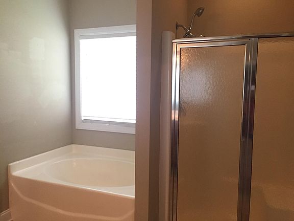 Master bath has separate garden tub and shower 