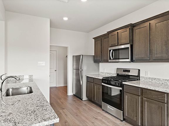 The kitchen has sprawling granite countertops.