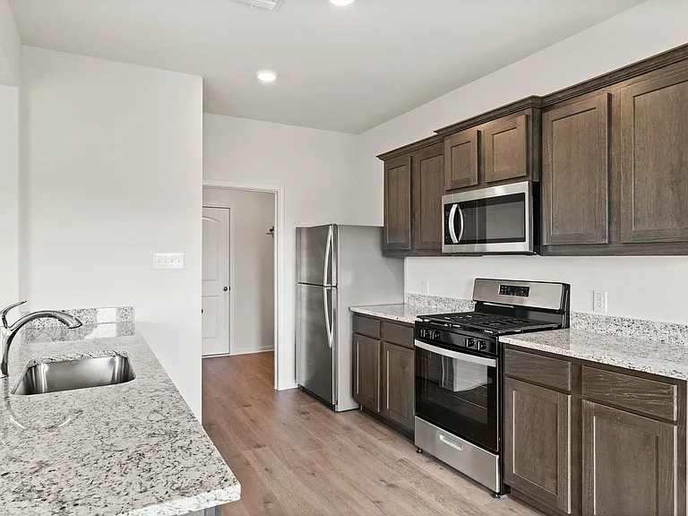 The kitchen has sprawling granite countertops.