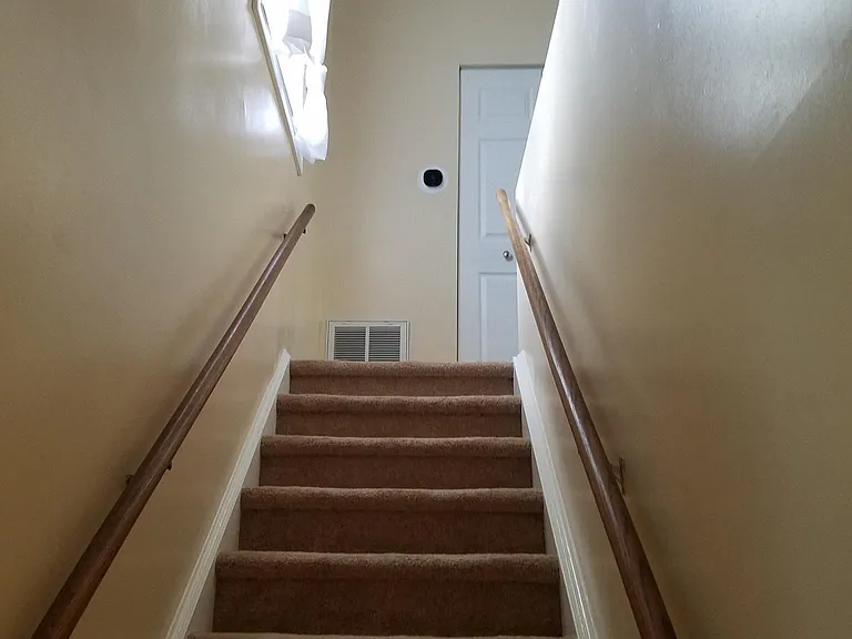 Stairs leading up to main living area from ground floor entrance.
