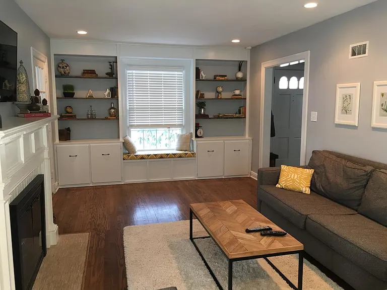Living room with builtin shelves and window seat