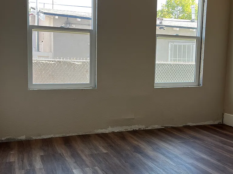Bedroom 2. Please note the baseboard has been installed since the picture was taken.