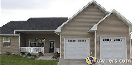 View from front of house: lovely porch, perennial garden, shrubs