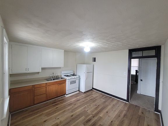 Eat in kitchen with new plank flooring with door to private back deck