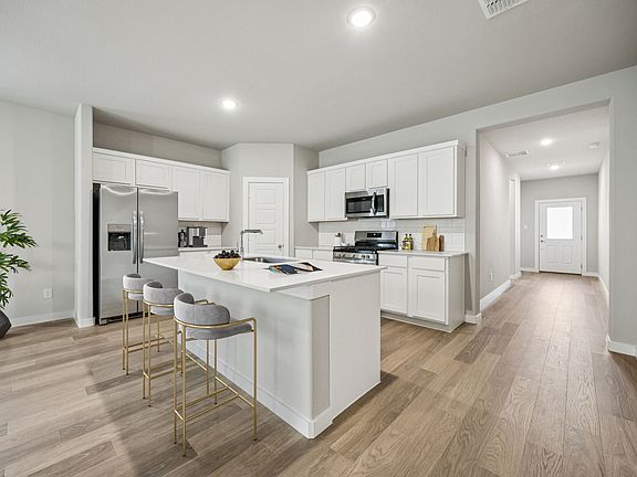 Kitchen in the Holden home plan by Trophy Signature Homes - REPRESENTATIVE PHOTO