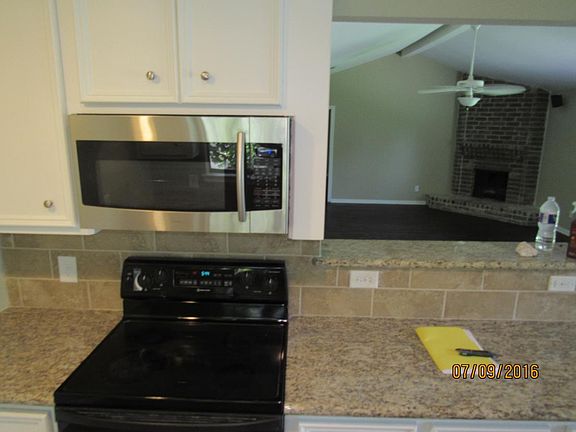 Kitchen with Stove and Granite Countertops