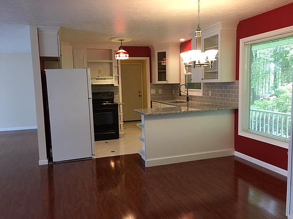 Bright kitchen with adjacent dining area and living room