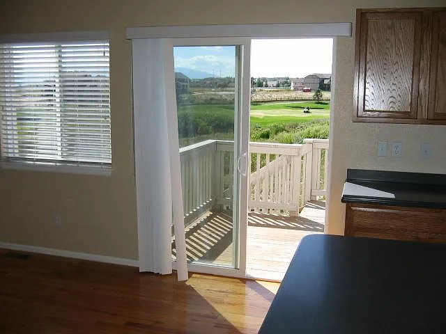 This is the rear door leading to the back deck and the 16th hole. A new, larger deck has recently been installed. Note the premium solid-surface Corian countertops.