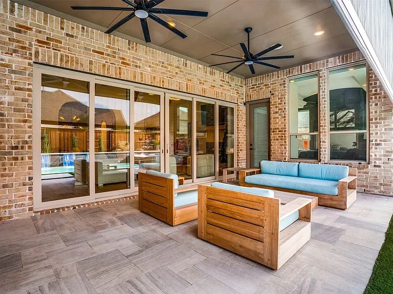 Covered patio featuring a brick exterior and a tiled floor