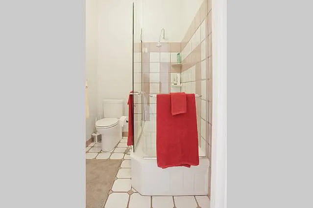 Remodeled Tiled Bathroom with Glass Shower/Tub