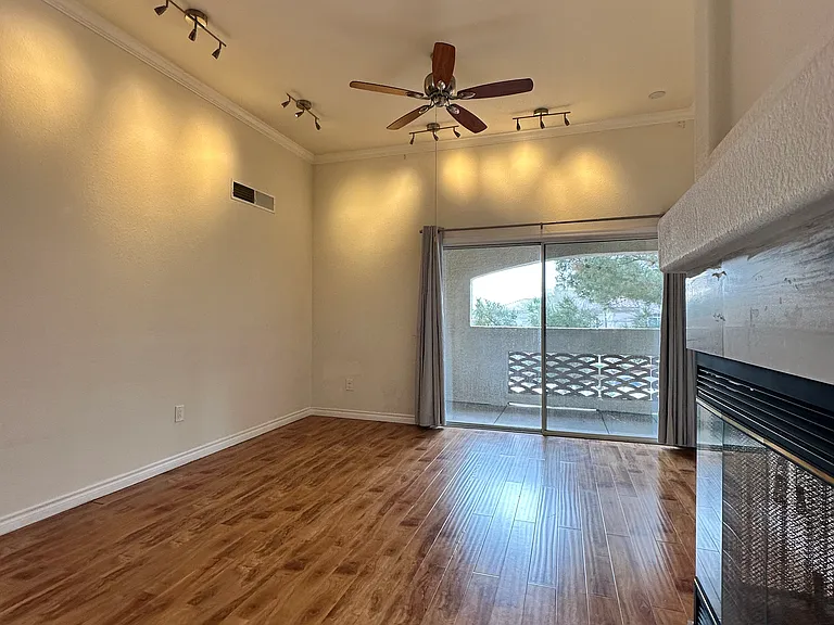 Enjoy an open kitchen featuring granite countertops and a direct view of the living room, fireplace, and balcony.