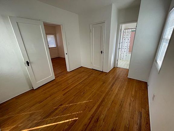Bedroom looking to living room and bathroom.