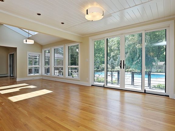 Dining area with wall of glass overlooking pool