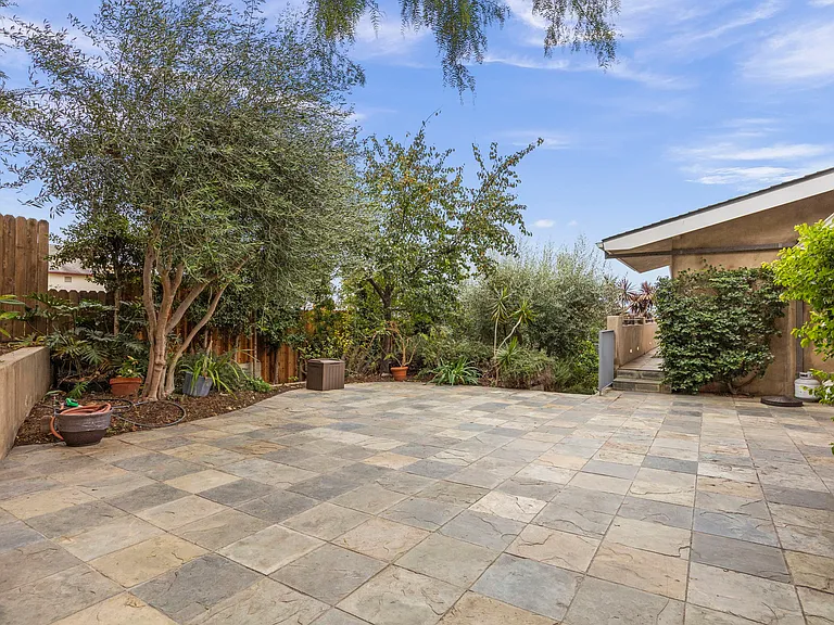 Mid-level patio with walkway to Unit B at end.