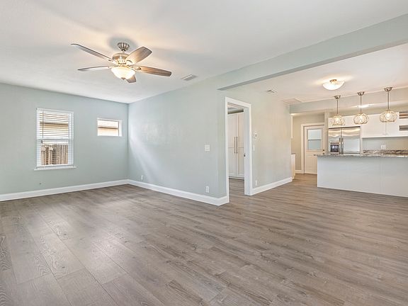 The open-concept living room is filled with natural light and flows seamlessly into the kitchen and dining areas_perfect for relaxing or entertaining.