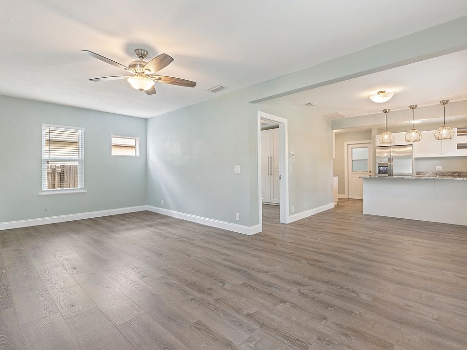 The open-concept living room is filled with natural light and flows seamlessly into the kitchen and dining areas_perfect for relaxing or entertaining.