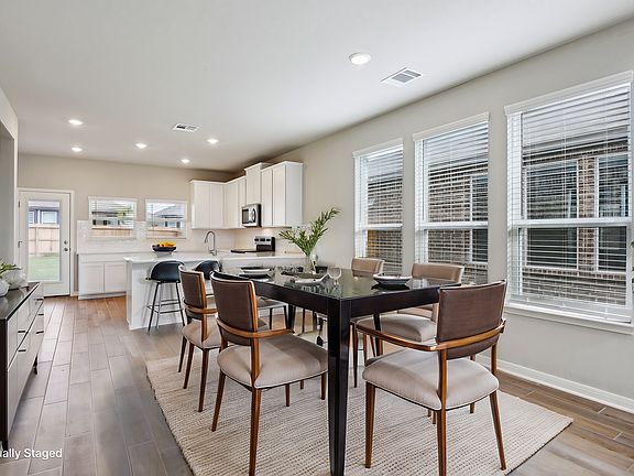 Virtually staged dining room in the Medina floorplan at a Meritage Homes community.