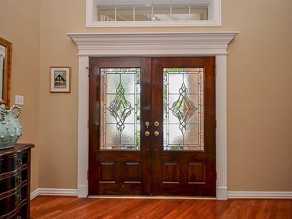 Elegant entry with double doors and leaded glass. The extensive molding in this home will wow you.