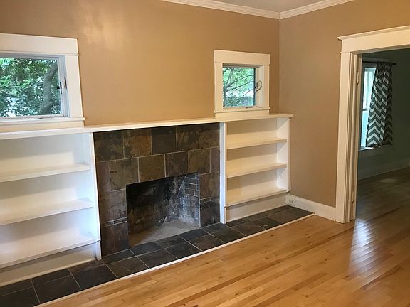 Dining Room/Den with Built-in Book Shelves & Decorative (sealed) Fire Place. Modern Casement Windows with Screens. Hardwood Floors
(photo from front door facing southwest towards living room)