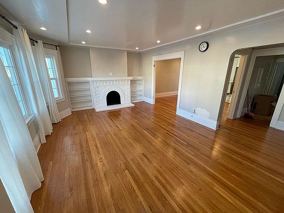 Living room with beautiful hardwood floors and fireplace.