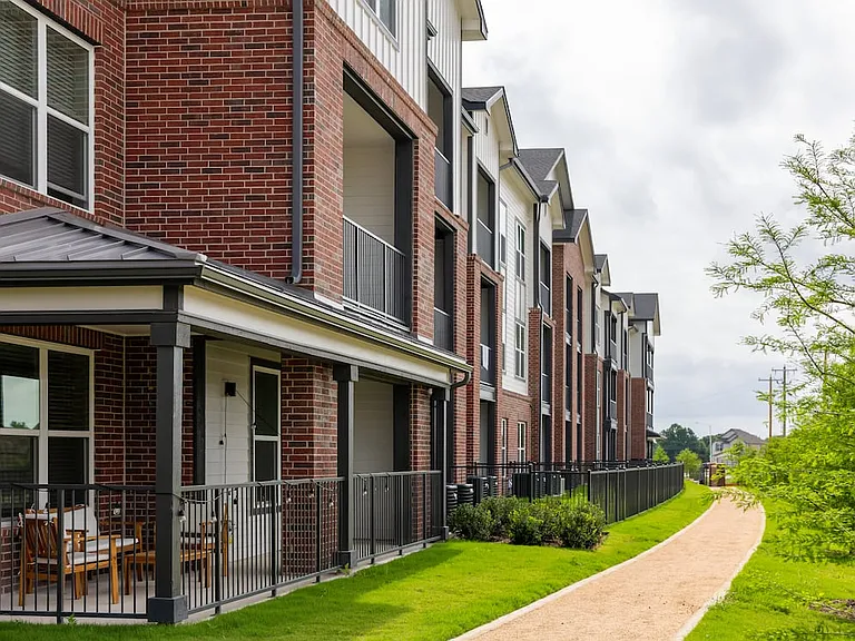 Building exterior with fenced-in yards (select homes)