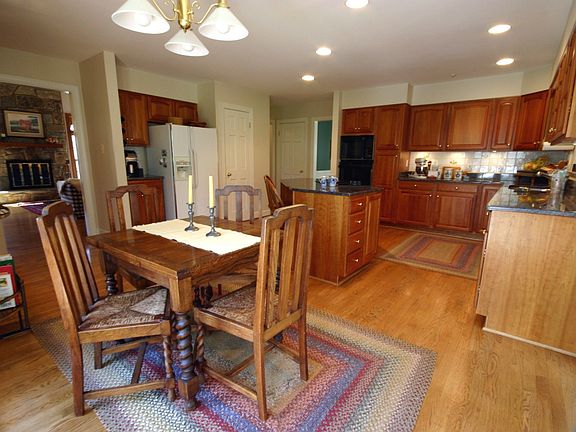 Updated kitchen with center island, hardwood floors, breakfast area