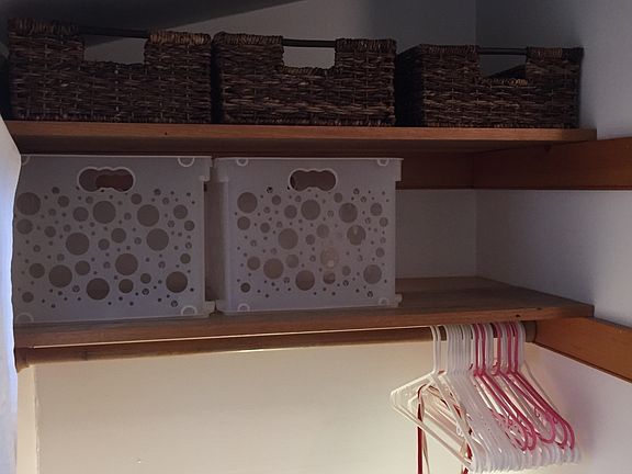 Over the steps storage shelves and hanging.
