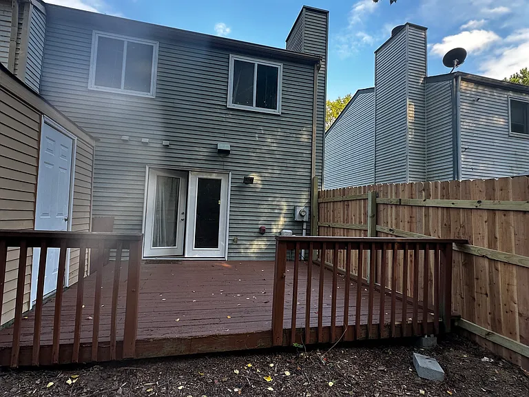 house and deck from back of yard (fenced).