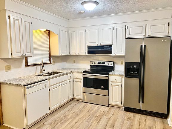 New granite counter tops with freshly painted cabinetry