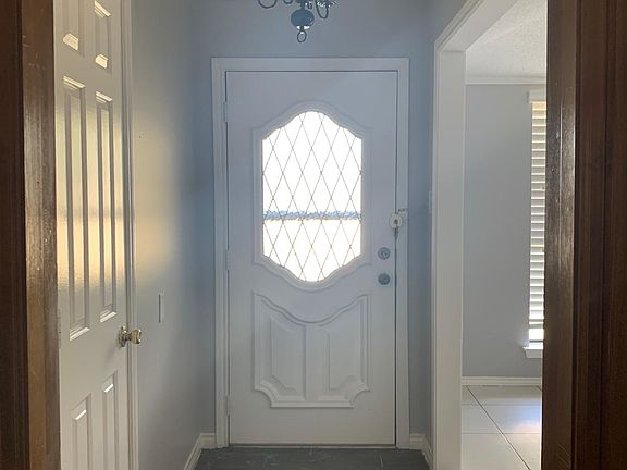 View of front door from inside hall ( left is closet, right leads into dining)