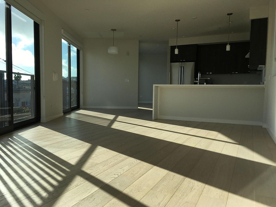 Open floor-plan and floor-to-ceiling windows fill this unit with light in sunny Mission district.