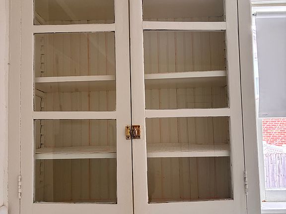 Glass cabinets in the kitchen. This house has so much charm and warmth!