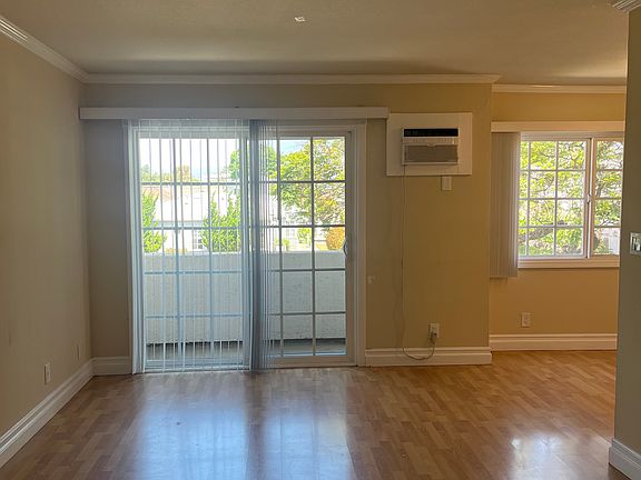 Living Room with Attached Sliding Door Leading to Balcony