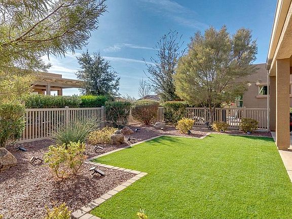 Fenced backyard with artificial turf