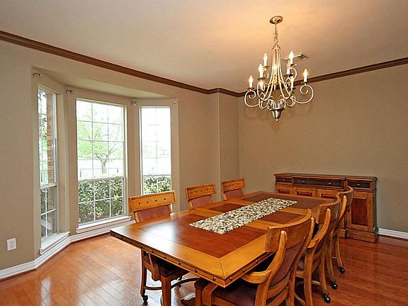 The over-sized Formal Dining is the ideal place to enjoy special meals or host fabulous dinner parties! Note: The pretty moldings, gleaming floors and upgraded chandelier.