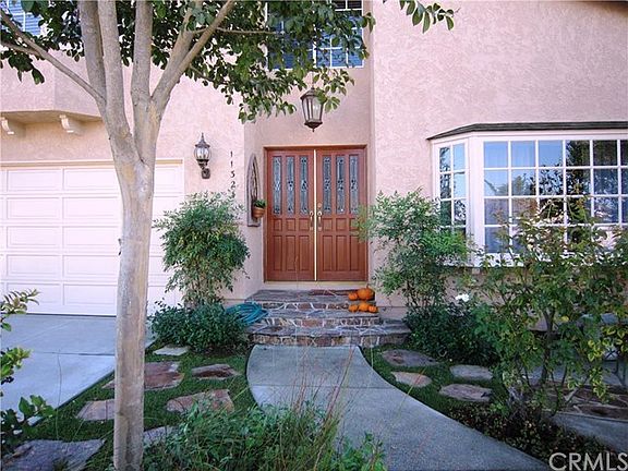 Automatic sprinklers front and back, garage door opener, 220V in garage, wooden segmented garage door, new concrete driveway.