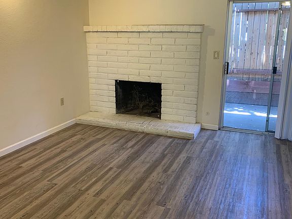 Faux vinyl in living area, and wood burning fireplace.