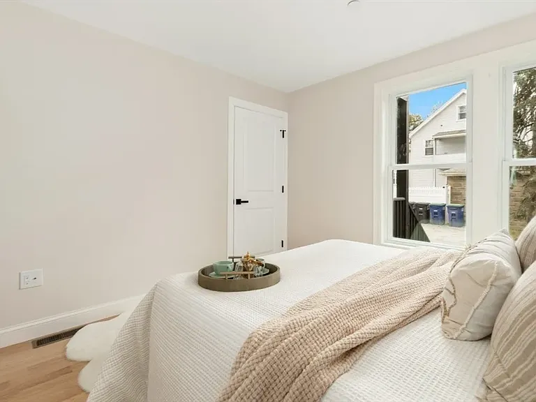Your private sanctuary: spacious primary suite, featuring brand-new flooring and abundant natural light.