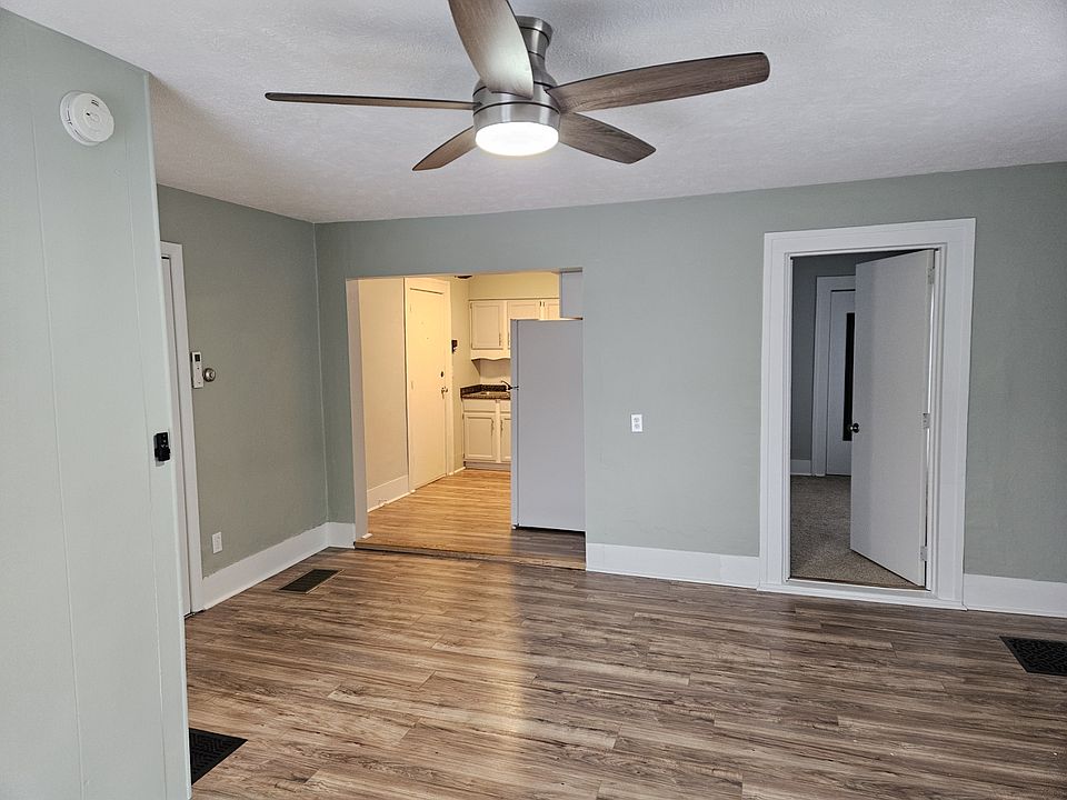 Living Room looking toward kitchen and unit entry door - back left. Bedroom door on right.