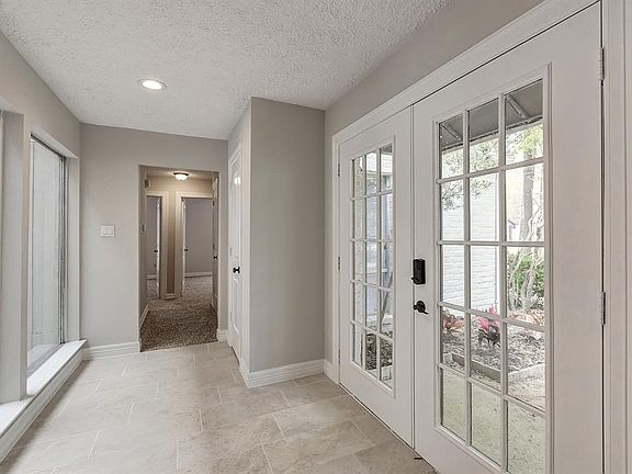 The entry has tile floors and double entry French doors.