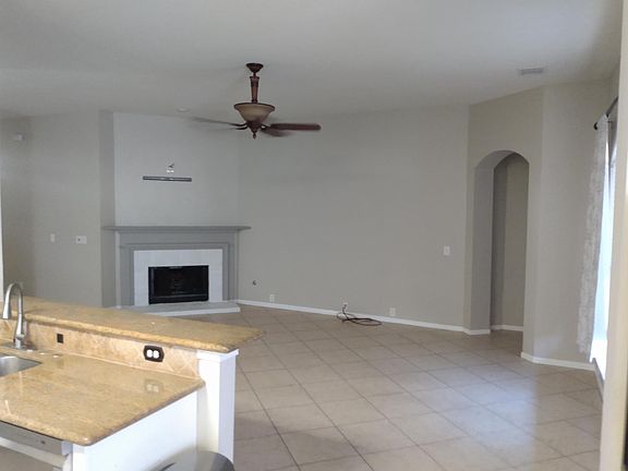 View from kitchen extending to living room woth high ceilings