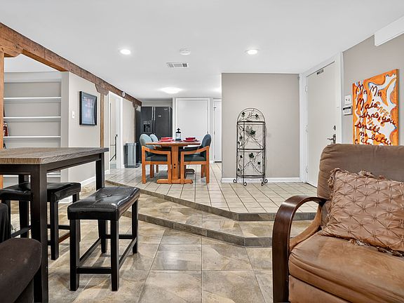 Entrance to kitchen, living room, with built-in bookcases.
