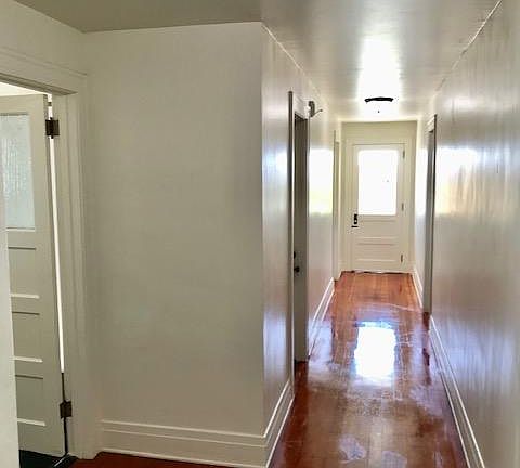 Hallway to bathroom , bedroom , office, and 2nd entrance , security screen door (not shown). Laundry room adjacent