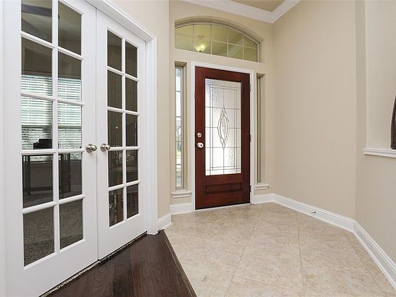 Front entry also features leaded glass front door with sidelights and transom window above. Study sits to the left.