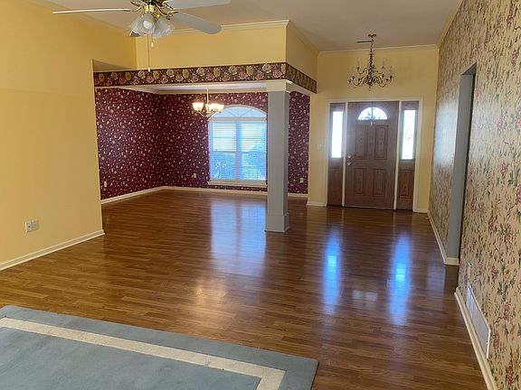 Living room looking toward front door and dining area