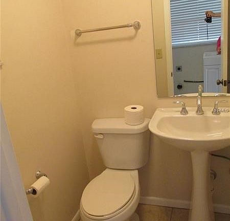 Downstairs half bathroom across from laundry area.