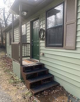Small entry porch is covered and has 4 steps to arrive to the front door.